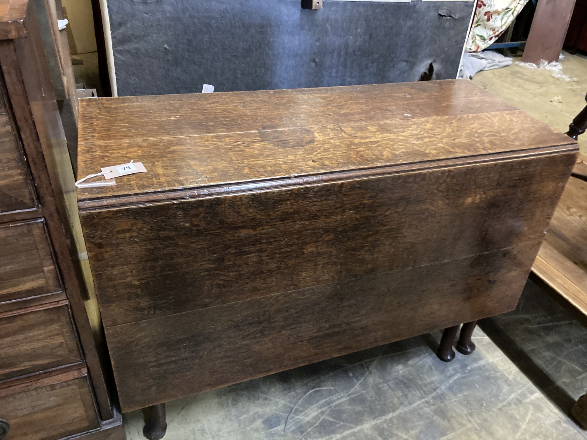 A George III oak pad foot drop leaf table, width106, length 143cm extended, height 72cm